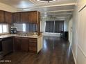 Open kitchen with dark wood cabinets and stainless steel appliances at 2460 E Main St # G3, Mesa, AZ 85213