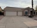 House exterior with a three car garage and driveway at 10505 E Emerald Cir, Mesa, AZ 85208