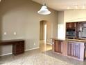 Spacious kitchen with island, dark wood cabinets, and stainless steel appliances at 21978 N Dietz Dr, Maricopa, AZ 85138