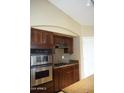 Kitchen features double oven, gas cooktop, and ample wood cabinetry at 21978 N Dietz Dr, Maricopa, AZ 85138