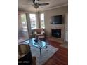 Living room with hardwood floors, fireplace, and plenty of natural light at 7009 E Acoma Dr # 2037, Scottsdale, AZ 85254