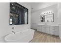 Elegant bathroom with a freestanding tub, double vanity, and large mirror at 39220 N 30Th Dr, Phoenix, AZ 85086