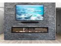 Modern linear fireplace with a large flat-screen TV above at 39220 N 30Th Dr, Phoenix, AZ 85086