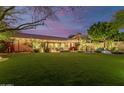 Spacious backyard featuring a large grassy area, pool, and home at 8919 E Calle Del Palo Verde --, Scottsdale, AZ 85255