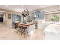 Gourmet kitchen with blue cabinets, an island, and pot rack at 8919 E Calle Del Palo Verde --, Scottsdale, AZ 85255