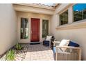 Inviting front entry with red door and comfortable seating area at 9649 E Solina Ave, Mesa, AZ 85212