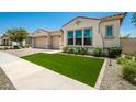 Beautiful stucco home with two-car garage and artificial turf lawn at 9649 E Solina Ave, Mesa, AZ 85212