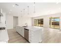 Open concept kitchen with island and stainless steel appliances at 23997 N 172Nd Ave, Surprise, AZ 85387