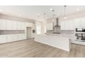Modern kitchen with white cabinets, quartz countertops, and island at 23997 N 172Nd Ave, Surprise, AZ 85387
