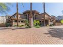 Attractive exterior of a multi-story building with palm trees and a brick driveway at 5350 E Deer Valley Dr # 4271, Phoenix, AZ 85054