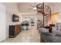 Open living area with spiral staircase, kitchen, and seating at 4901 S Calle Los Cerros Dr # 267, Tempe, AZ 85282