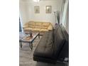 Living room with tan and brown leather sofas at 12123 W Bell Rd # 259, Surprise, AZ 85378