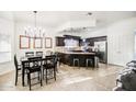 Eat-in kitchen with dark cabinets, island, and chandelier at 772 N Swan Dr, Gilbert, AZ 85234