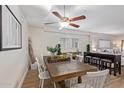 Dining area featuring a rustic wood table and white chairs at 351 E Thomas Rd # D108, Phoenix, AZ 85012
