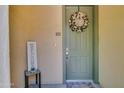 Well-lit entryway featuring a charming 'Home Sweet Home' wreath at 14575 W Mountain View Blvd # 721, Surprise, AZ 85374