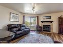 Living room featuring a fireplace, comfortable seating, and patio access at 16715 E El Lago Blvd # 116, Fountain Hills, AZ 85268