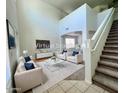 Spacious living room with high ceilings and a staircase at 17514 W Caribbean Ln, Surprise, AZ 85388