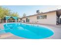 Large kidney shaped pool with a covered patio at 14801 N 39Th Ave, Phoenix, AZ 85053