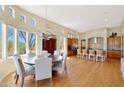 Elegant dining room with hardwood floors and kitchen access at 8982 E Rusty Spur Pl, Scottsdale, AZ 85255