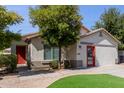 Single story home with red door and artificial turf at 10916 E Verbina Ln, Florence, AZ 85132