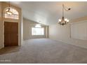 Bright living room with neutral carpeting and high ceilings at 10923 W Escuda Dr, Sun City, AZ 85373