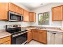 Kitchen with wood cabinets and stainless steel appliances at 15818 N 25Th St # 112, Phoenix, AZ 85032