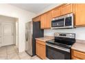 Kitchen with stainless steel appliances and wood cabinets at 15818 N 25Th St # 112, Phoenix, AZ 85032