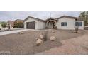 Modern desert home with a two-car garage and attractive landscaping at 9462 E Mogollon Trl, Gold Canyon, AZ 85118