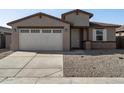 Two-story house with a two-car garage, landscaping, and a light-colored exterior at 37287 W Patterson St, Maricopa, AZ 85138