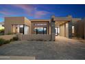 Modern home with a courtyard entry and stone details at 10249 E Joy Ranch Rd, Scottsdale, AZ 85262