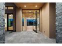 Elegant entryway with glass doors and a wood ceiling at 10249 E Joy Ranch Rd, Scottsdale, AZ 85262
