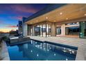Inviting pool and spa with a covered patio and outdoor kitchen at 10249 E Joy Ranch Rd, Scottsdale, AZ 85262