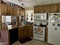 Galley kitchen with wood cabinets and appliances at 4065 E University Dr # 462, Mesa, AZ 85205