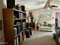 Living room with sofa, shelving, and artwork at 4065 E University Dr # 462, Mesa, AZ 85205