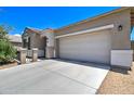 Single story home with a two-car garage and desert landscaping at 19731 N Ben Ct, Maricopa, AZ 85138