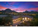 Luxury estate at dusk, showcasing beautiful landscaping at 10379 E White Feather Ln, Scottsdale, AZ 85262