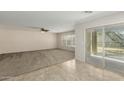 Spacious living room with tile and carpet flooring, and access to backyard at 17214 W Gibson Ln, Goodyear, AZ 85338