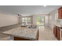 Modern kitchen with island, stainless steel appliances, and wood cabinets at 17214 W Gibson Ln, Goodyear, AZ 85338