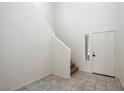 Bright entryway with tiled floor and staircase at 2084 N 214Th Dr, Buckeye, AZ 85396