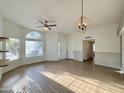 Open living room with laminate flooring and large windows at 4423 E Ponca St, Phoenix, AZ 85044