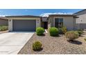 Single story home with two-car garage and desert landscaping at 19031 W Palo Verde Dr, Litchfield Park, AZ 85340