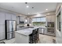 Modern kitchen with granite island and stainless steel appliances at 41650 W Harvest Moon Dr, Maricopa, AZ 85138