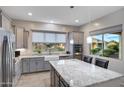 Modern kitchen with granite island and farmhouse sink at 41650 W Harvest Moon Dr, Maricopa, AZ 85138