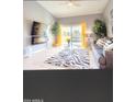 Living room with fireplace, balcony access, and modern decor at 7101 W Beardsley Rd # 452, Glendale, AZ 85308