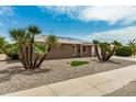 Side view of a tan brick ranch home with solar panels and desert landscaping at 18007 N 135Th Dr, Sun City West, AZ 85375