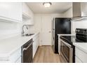 Modern kitchen with white cabinets and stainless steel appliances at 4015 S 45Th St, Phoenix, AZ 85040