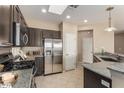 Modern kitchen features stainless steel appliances and granite countertops at 3007 W Plum Hollow Dr, Anthem, AZ 85086