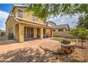 Landscaped backyard with a patio and artificial turf at 13431 W Rose Ln, Litchfield Park, AZ 85340