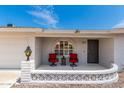 Charming front porch with red chairs and a decorative railing at 8064 E Madero Ave, Mesa, AZ 85209