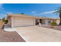 Ranch-style home with attached garage and landscaped front yard at 8064 E Madero Ave, Mesa, AZ 85209